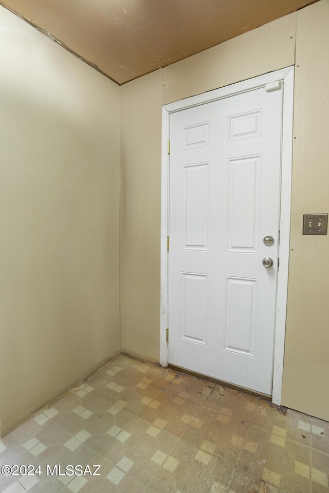 entryway with light tile patterned flooring