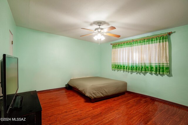 bedroom featuring ceiling fan and hardwood / wood-style flooring