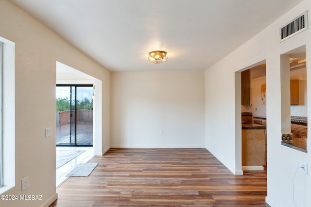 spare room with hardwood / wood-style floors