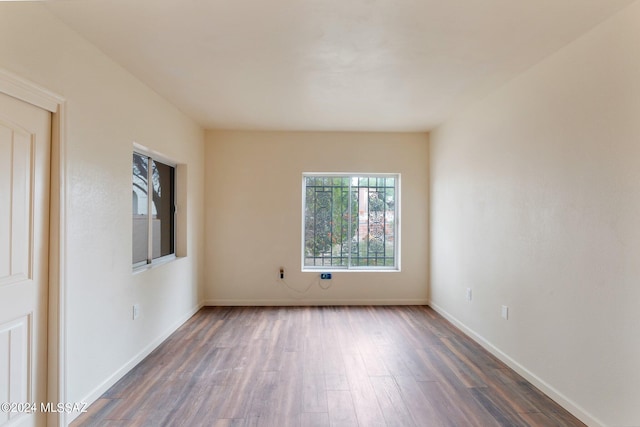 empty room featuring dark hardwood / wood-style flooring