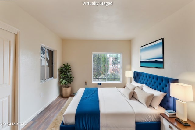 bedroom with hardwood / wood-style flooring