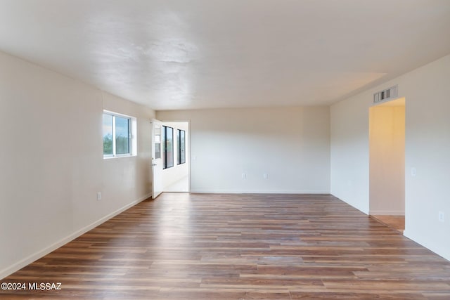 spare room with wood-type flooring