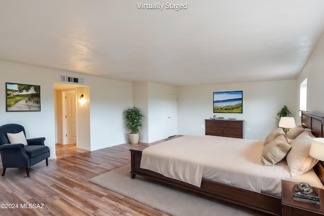 bedroom with hardwood / wood-style flooring