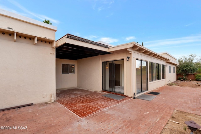 back of property featuring a patio area