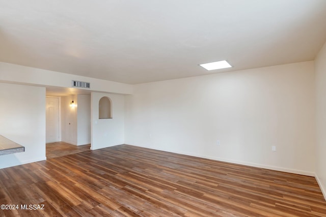 spare room with wood-type flooring