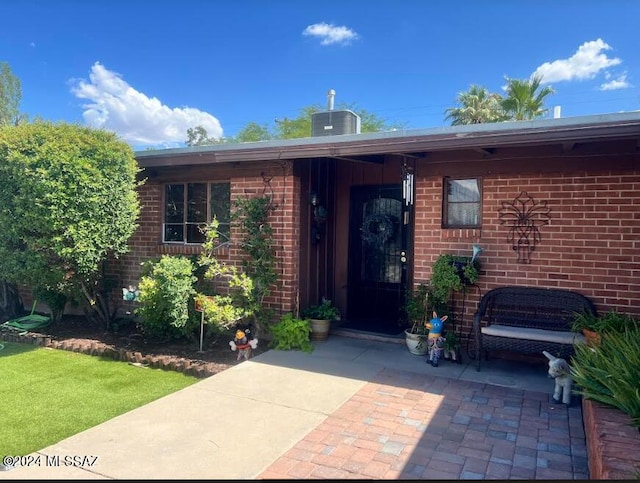 entrance to property featuring a patio