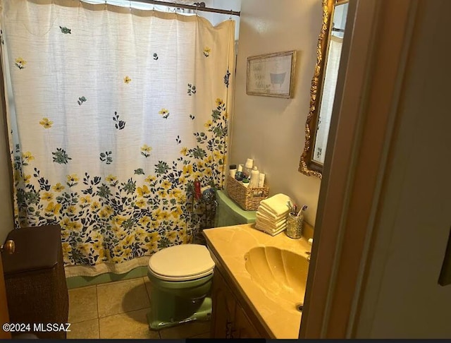 bathroom with vanity, toilet, and tile patterned floors