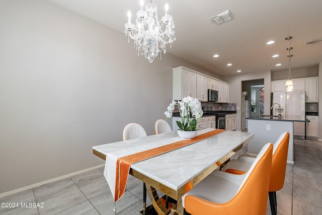 dining space featuring light tile patterned flooring, sink, and a notable chandelier