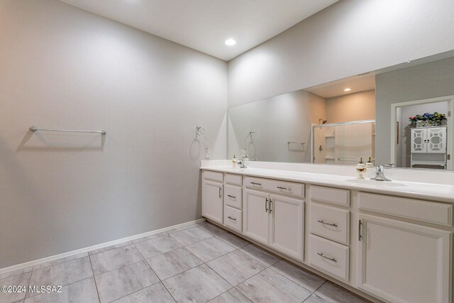 bathroom featuring vanity, an enclosed shower, and tile patterned floors