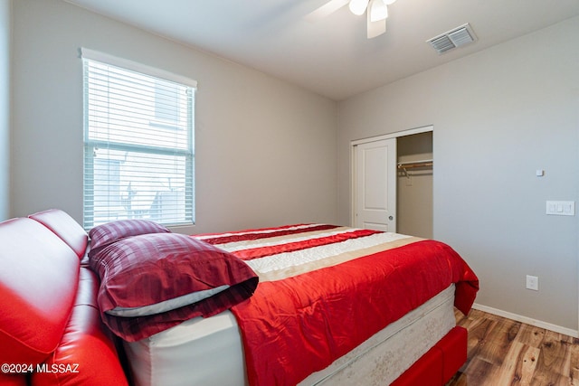 bedroom featuring wood-type flooring, ceiling fan, and a closet