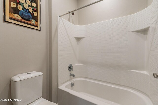 bathroom featuring shower / bathtub combination and toilet