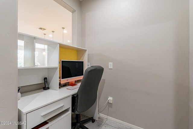 home office featuring built in desk and light tile patterned floors