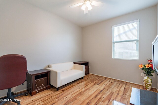 home office with ceiling fan and light wood-type flooring