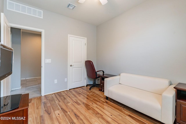 sitting room with light hardwood / wood-style floors and ceiling fan