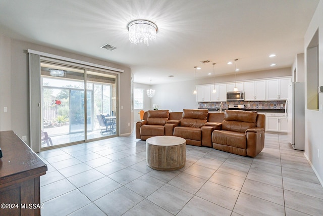 living room featuring an inviting chandelier and light tile patterned flooring