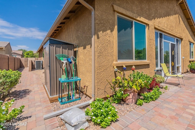 view of property exterior featuring a patio and central air condition unit