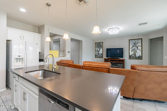 kitchen with dishwasher, white cabinetry, sink, and an island with sink