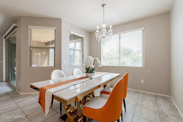 tiled dining room with a notable chandelier