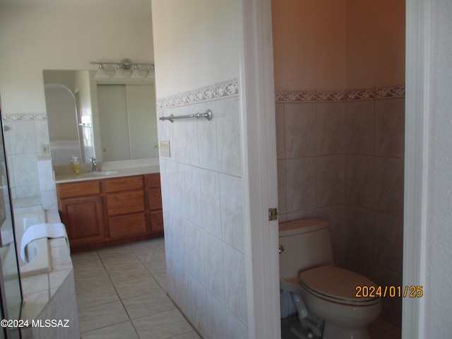 bathroom featuring vanity, tile walls, toilet, and tile patterned flooring