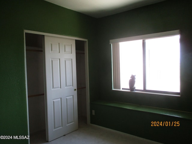 unfurnished bedroom with carpet flooring and a closet