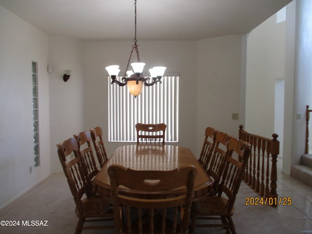 tiled dining space featuring a chandelier