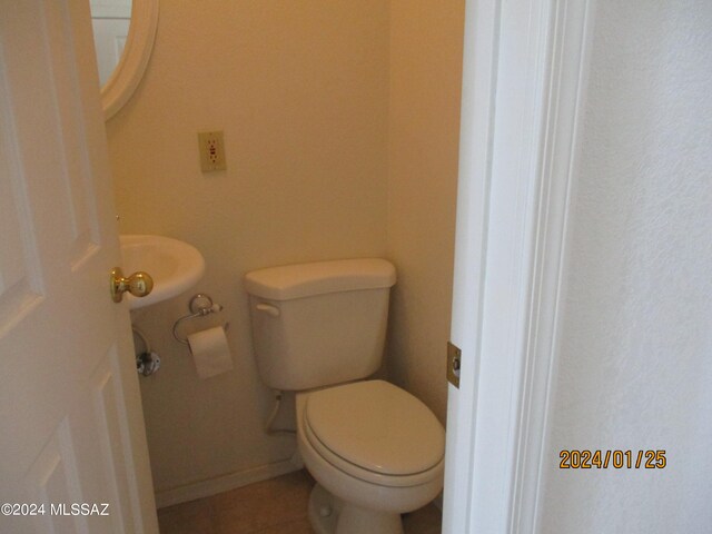 bathroom featuring toilet and tile patterned flooring