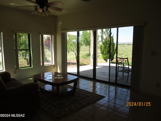 living room featuring light tile patterned flooring, a wealth of natural light, and ceiling fan