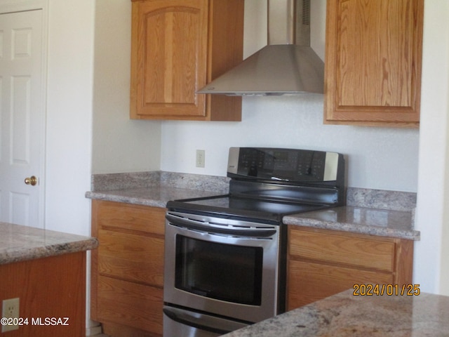 kitchen featuring light stone countertops, wall chimney exhaust hood, and electric stove