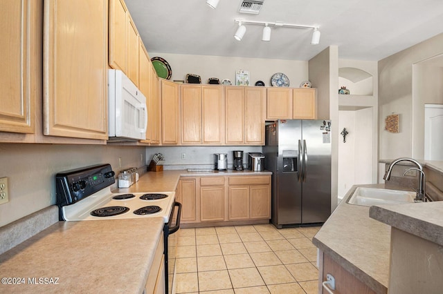 kitchen featuring light brown cabinetry, electric range oven, sink, and stainless steel refrigerator with ice dispenser