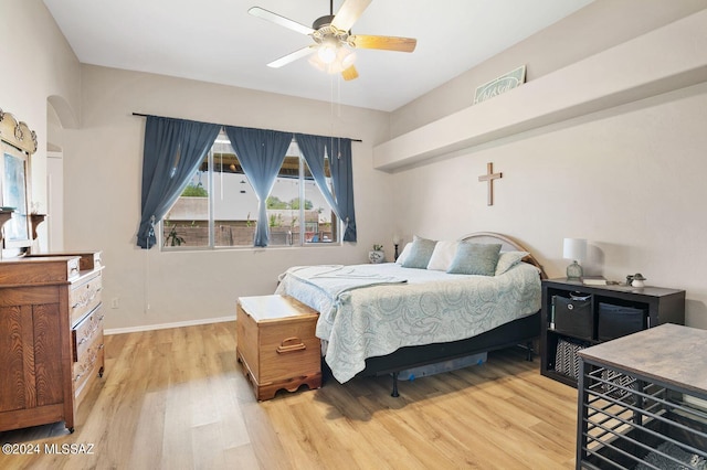 bedroom with light hardwood / wood-style flooring and ceiling fan