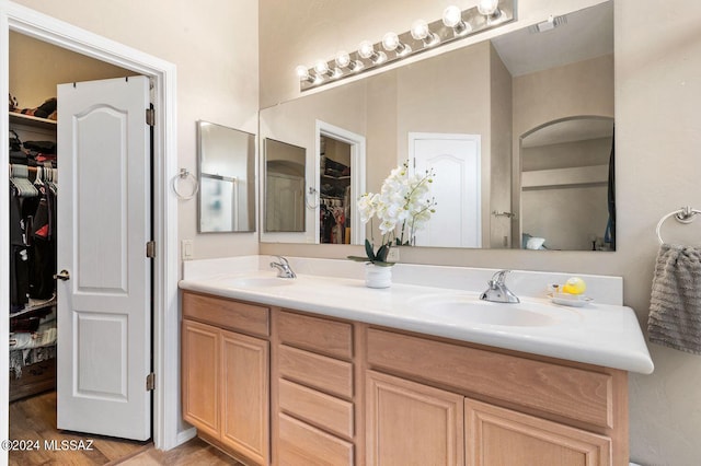 bathroom with vanity and hardwood / wood-style flooring