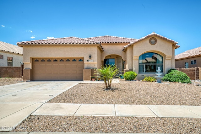 mediterranean / spanish house with a garage