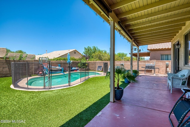 view of swimming pool with a lawn and a patio area