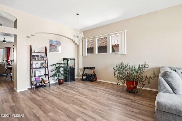 sitting room with wood-type flooring and a chandelier