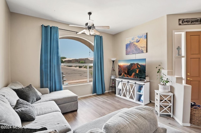 living room with ceiling fan and wood-type flooring