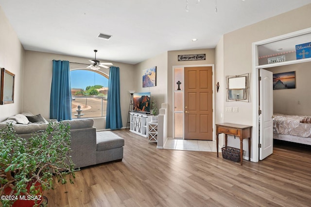 living room with ceiling fan and hardwood / wood-style floors