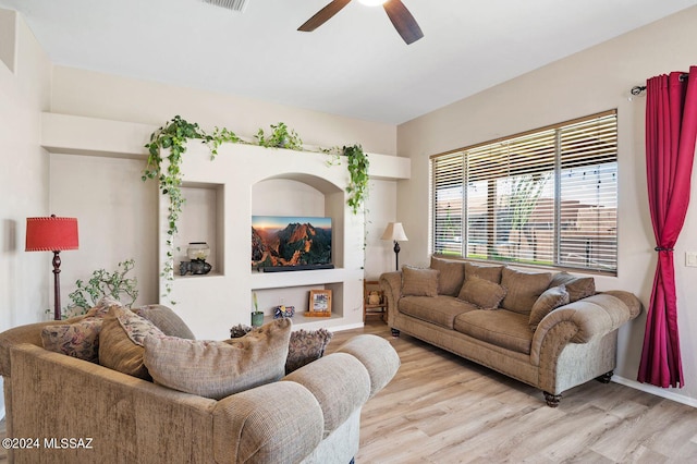 living room featuring light hardwood / wood-style flooring and ceiling fan