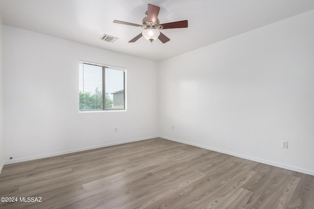 spare room featuring ceiling fan and light wood-type flooring