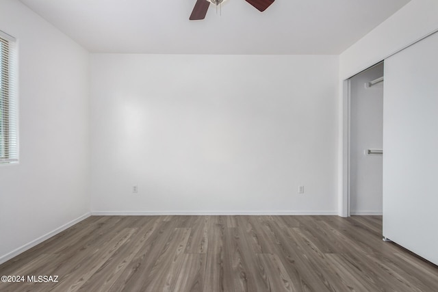 interior space with a closet, wood-type flooring, and ceiling fan