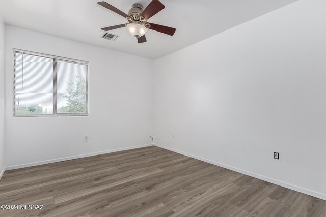 empty room featuring ceiling fan and hardwood / wood-style flooring