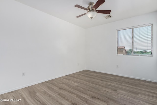 empty room with ceiling fan and hardwood / wood-style floors