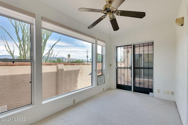 unfurnished sunroom featuring ceiling fan