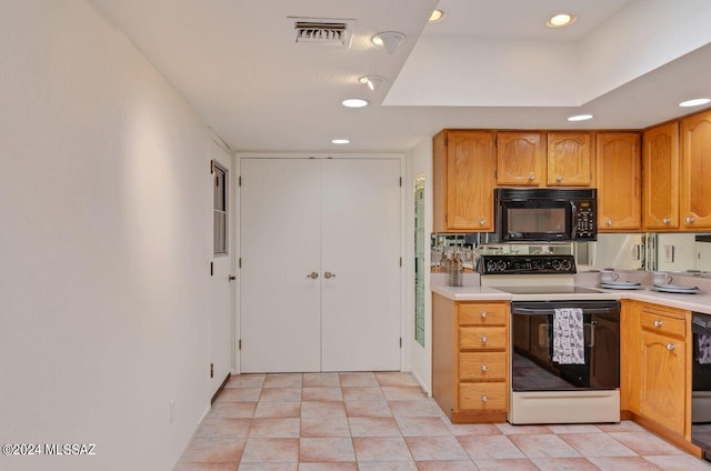 kitchen with recessed lighting, visible vents, light countertops, brown cabinets, and black appliances