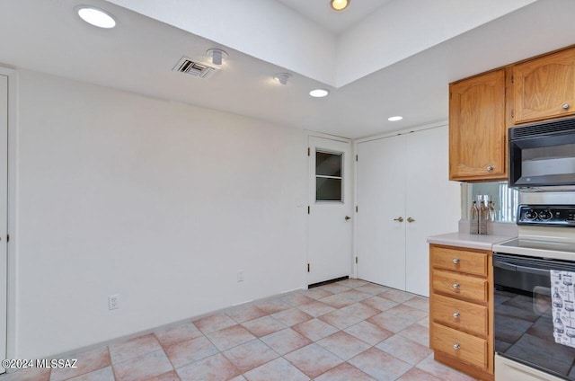 kitchen with visible vents, electric range oven, light countertops, black microwave, and recessed lighting