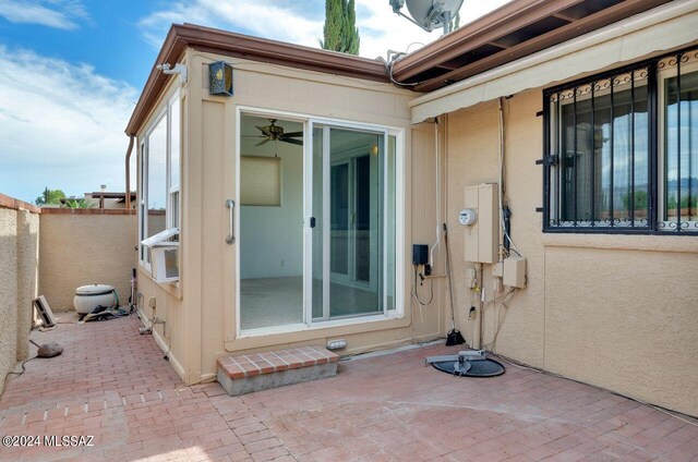 exterior space with ceiling fan