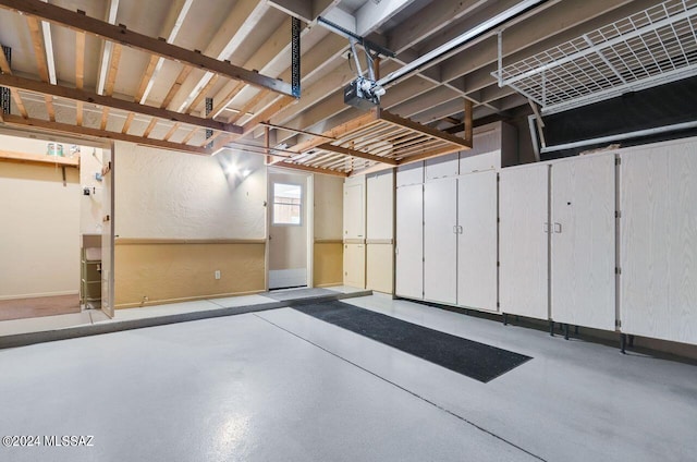 garage featuring a textured wall and a garage door opener