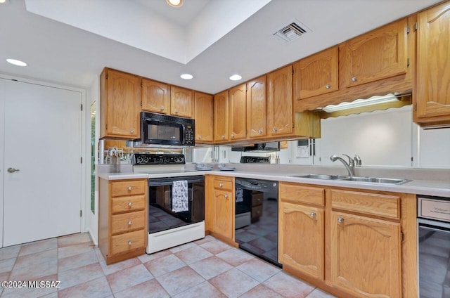 kitchen featuring light tile patterned floors, sink, and black appliances