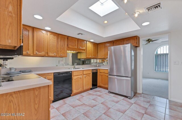 kitchen with a raised ceiling, light tile patterned flooring, white range with electric stovetop, and washing machine and clothes dryer