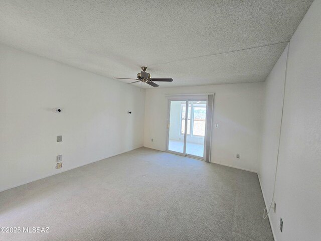 unfurnished bedroom with ceiling fan, a spacious closet, light carpet, ensuite bathroom, and a textured ceiling