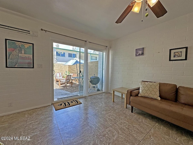 living room featuring ceiling fan and brick wall